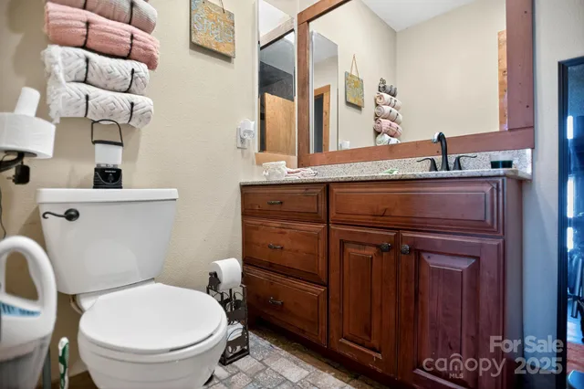a bathroom with a toilet a sink and mirror