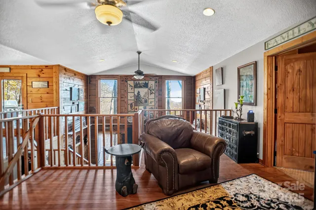 a living room with furniture a chandelier and a dining table