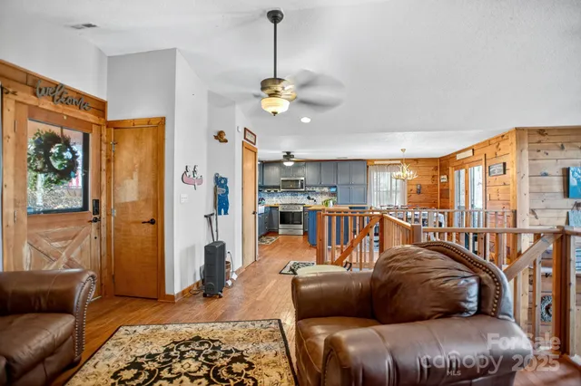 a living room with furniture ceiling fan and a window