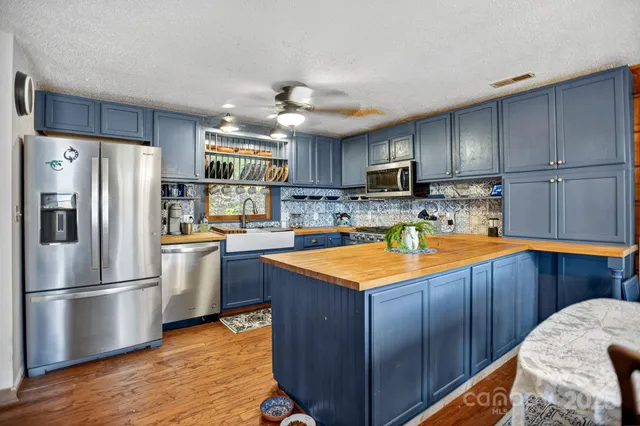 a kitchen with wooden cabinets and stainless steel appliances
