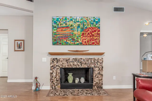 a spacious bedroom with a bed a couch and a chandelier