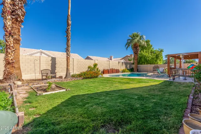 an aerial view of a house with a yard and trees