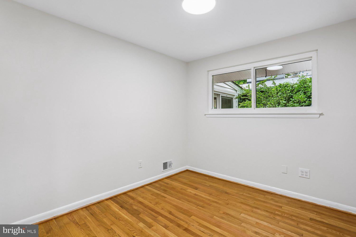 907 Hoyt Street Silver Spring, MD 20902 - Photo 36 of 69 an empty room with wooden floor and windows
