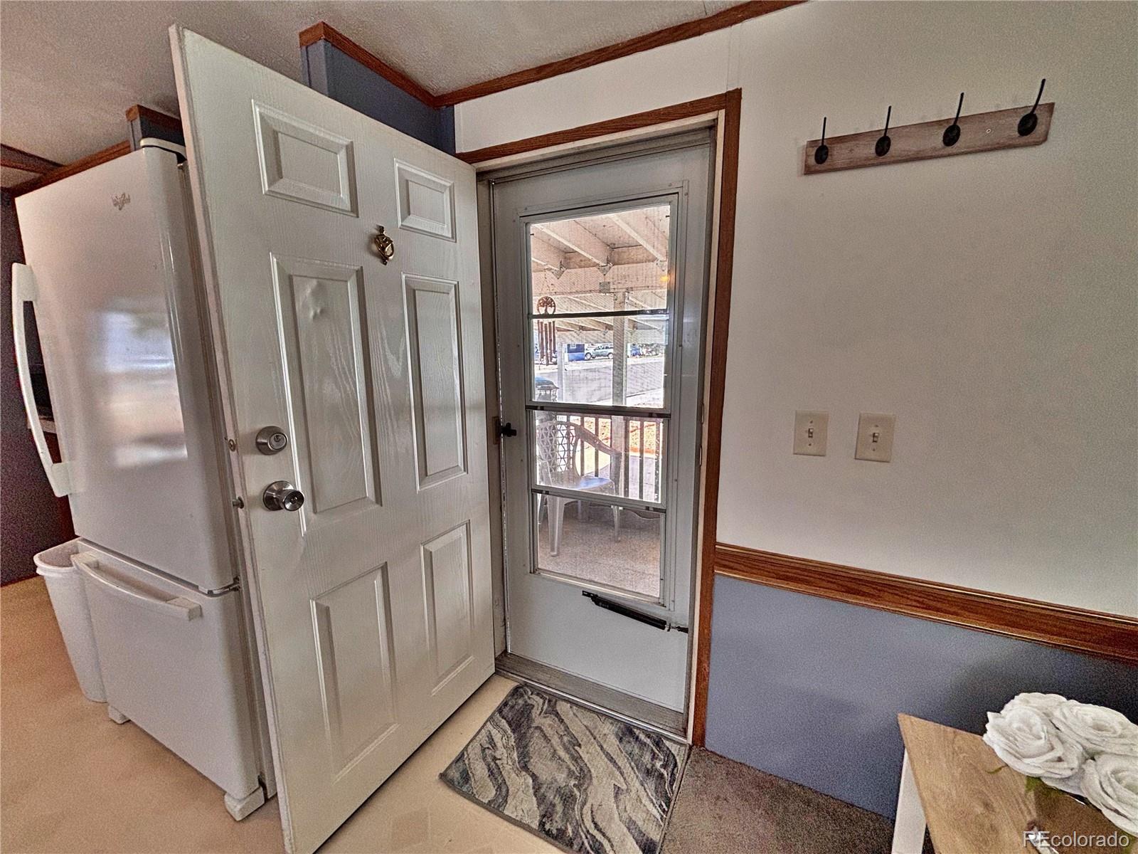 230 North 2nd Street Berthoud, CO 80513 - Photo 11 of 44 a view of wooden floor and a cabinet in a room