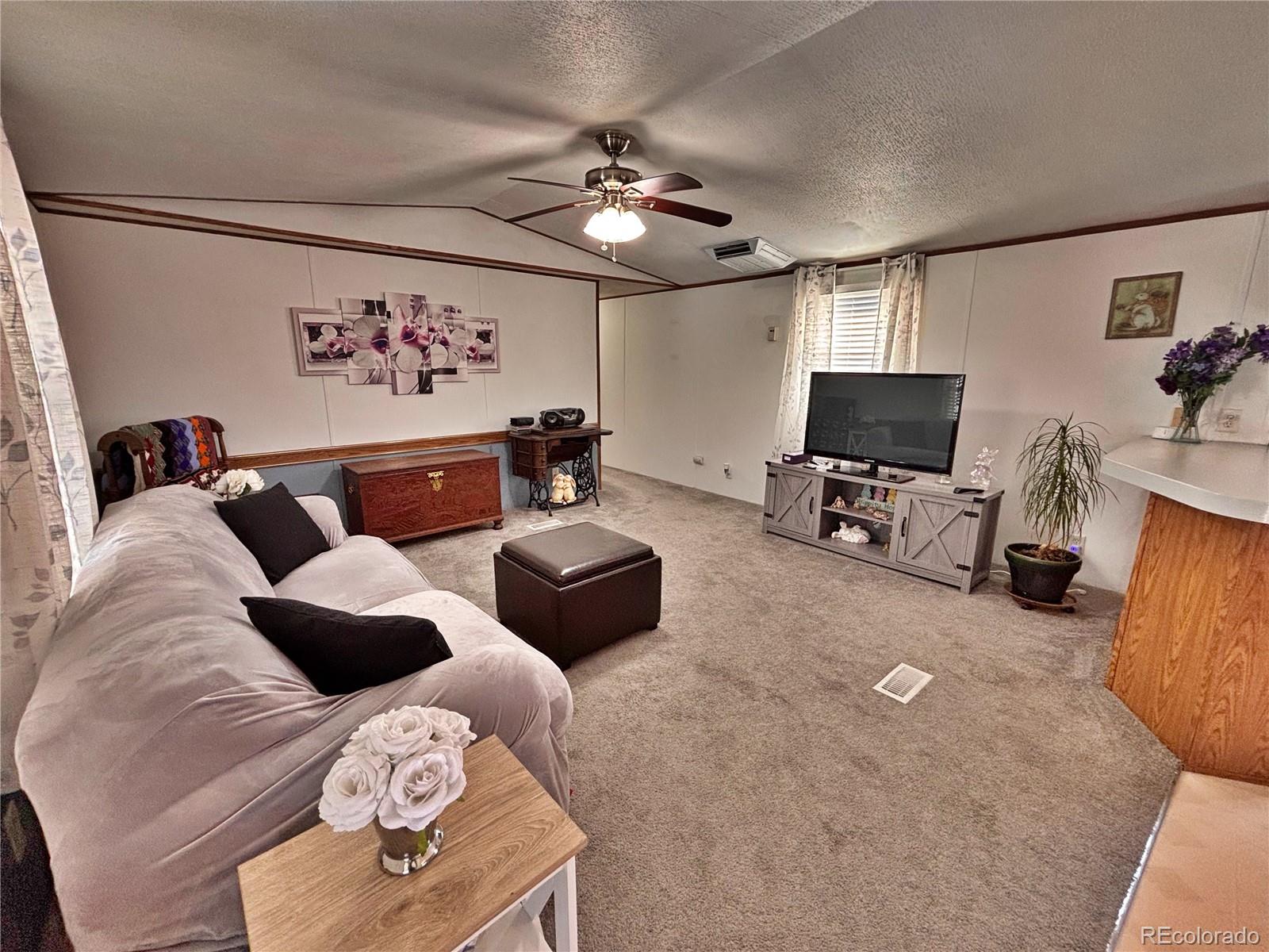 230 North 2nd Street Berthoud, CO 80513 - Photo 13 of 44 a living room with furniture and a flat screen tv