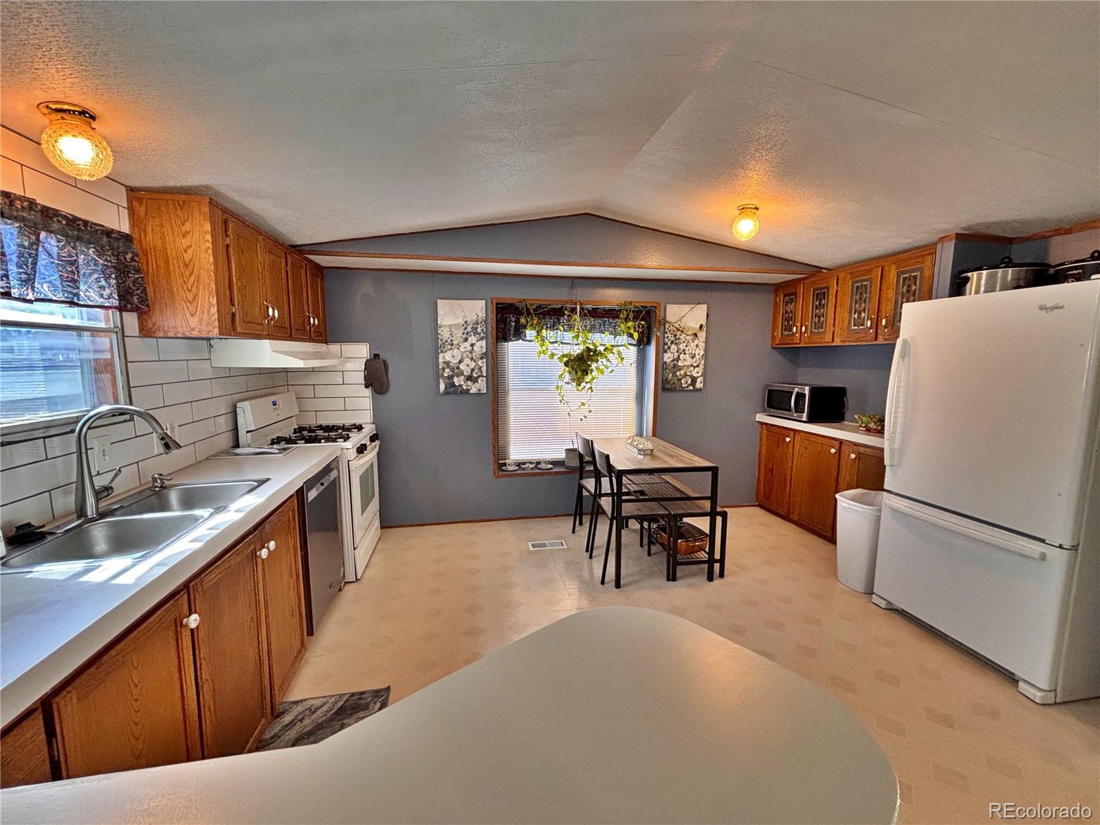 230 North 2nd Street Berthoud, CO 80513 - Photo 14 of 44 a kitchen with stainless steel appliances granite countertop a refrigerator stove and a sink