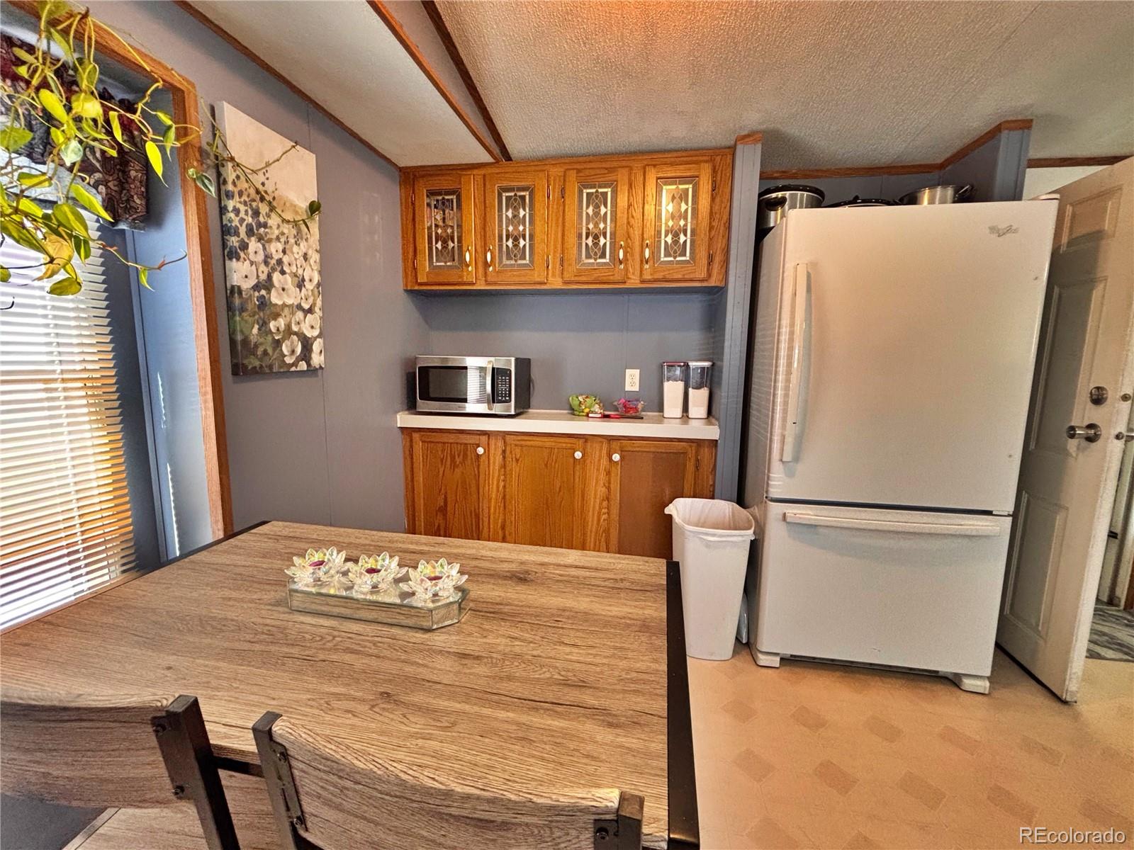 230 North 2nd Street Berthoud, CO 80513 - Photo 18 of 44 a white refrigerator freezer sitting in a kitchen