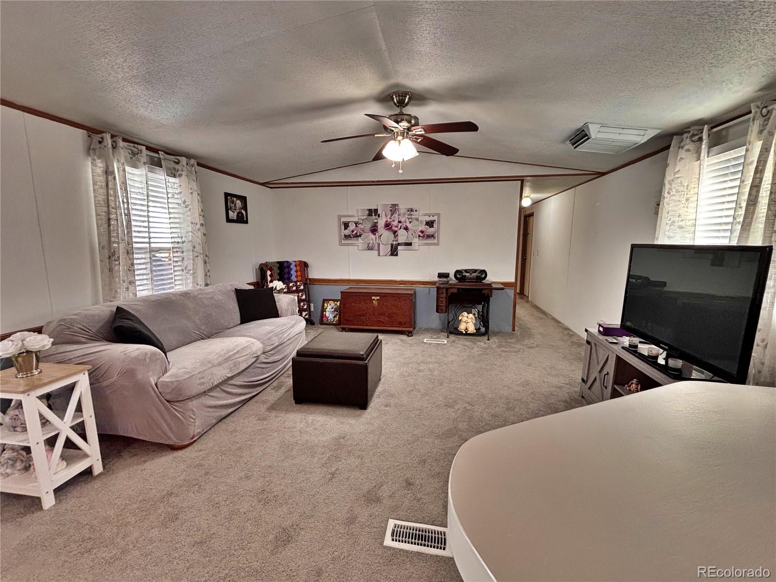 230 North 2nd Street Berthoud, CO 80513 - Photo 19 of 44 a living room with furniture and a flat screen tv