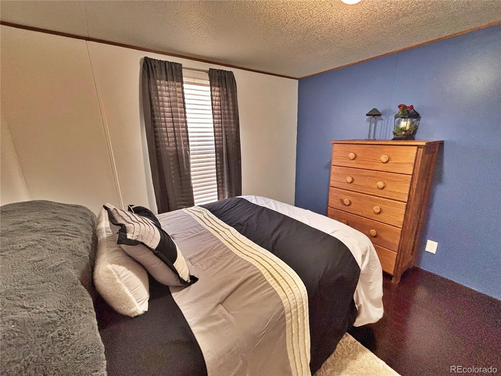 230 North 2nd Street Berthoud, CO 80513 - Photo 27 of 44 a bedroom with a bed and window