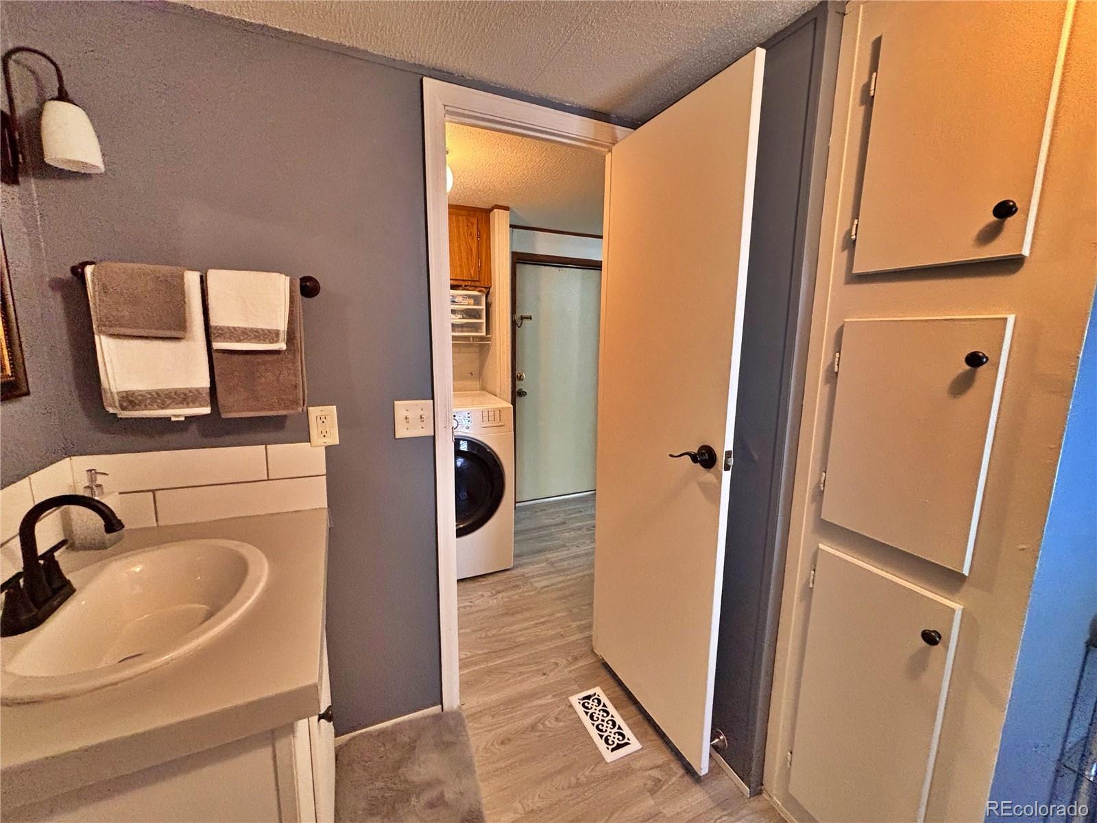 230 North 2nd Street Berthoud, CO 80513 - Photo 34 of 44 a bathroom with a sink a mirror and shower