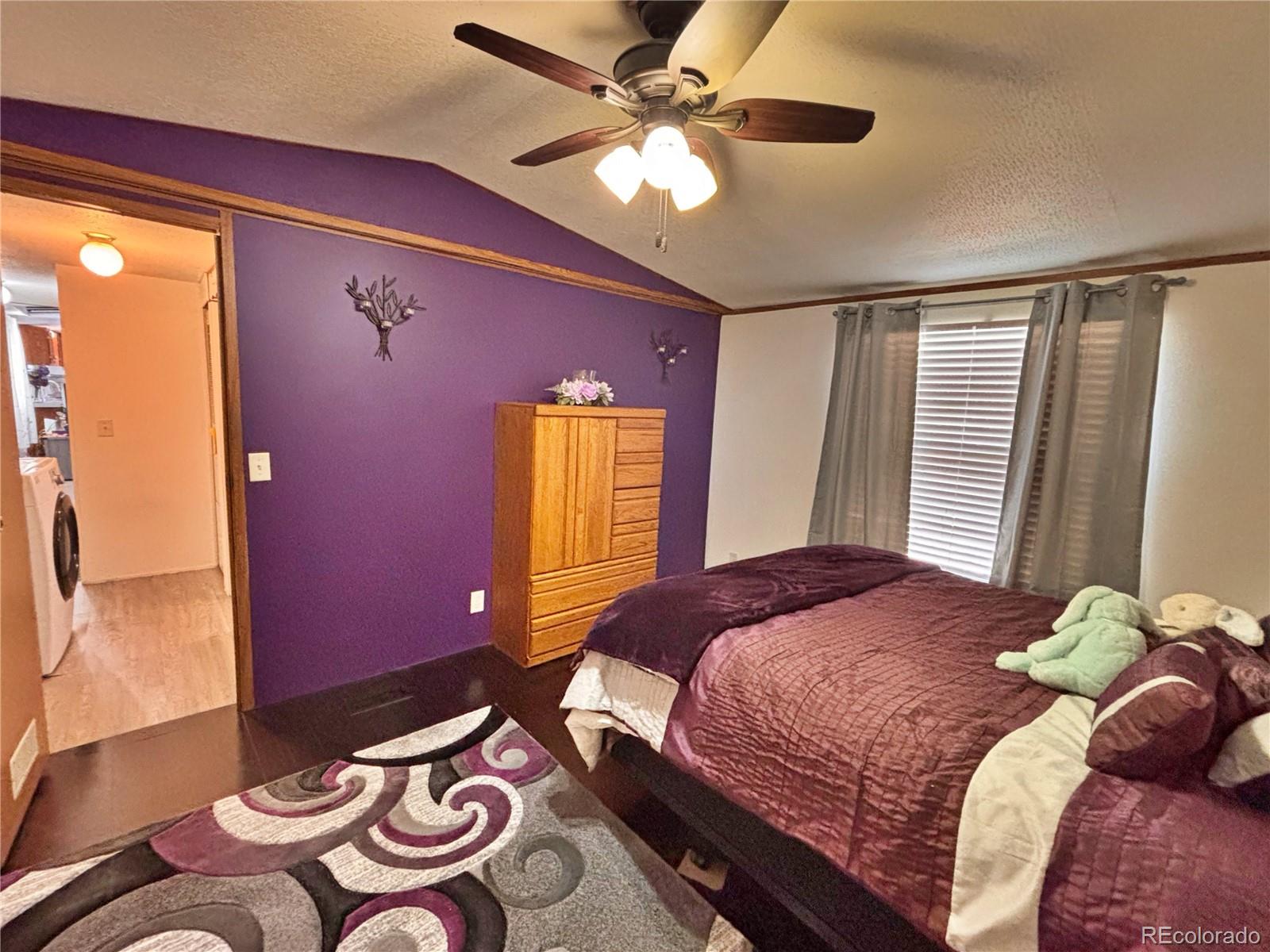 230 North 2nd Street Berthoud, CO 80513 - Photo 38 of 44 a bedroom with a bed and a chandelier