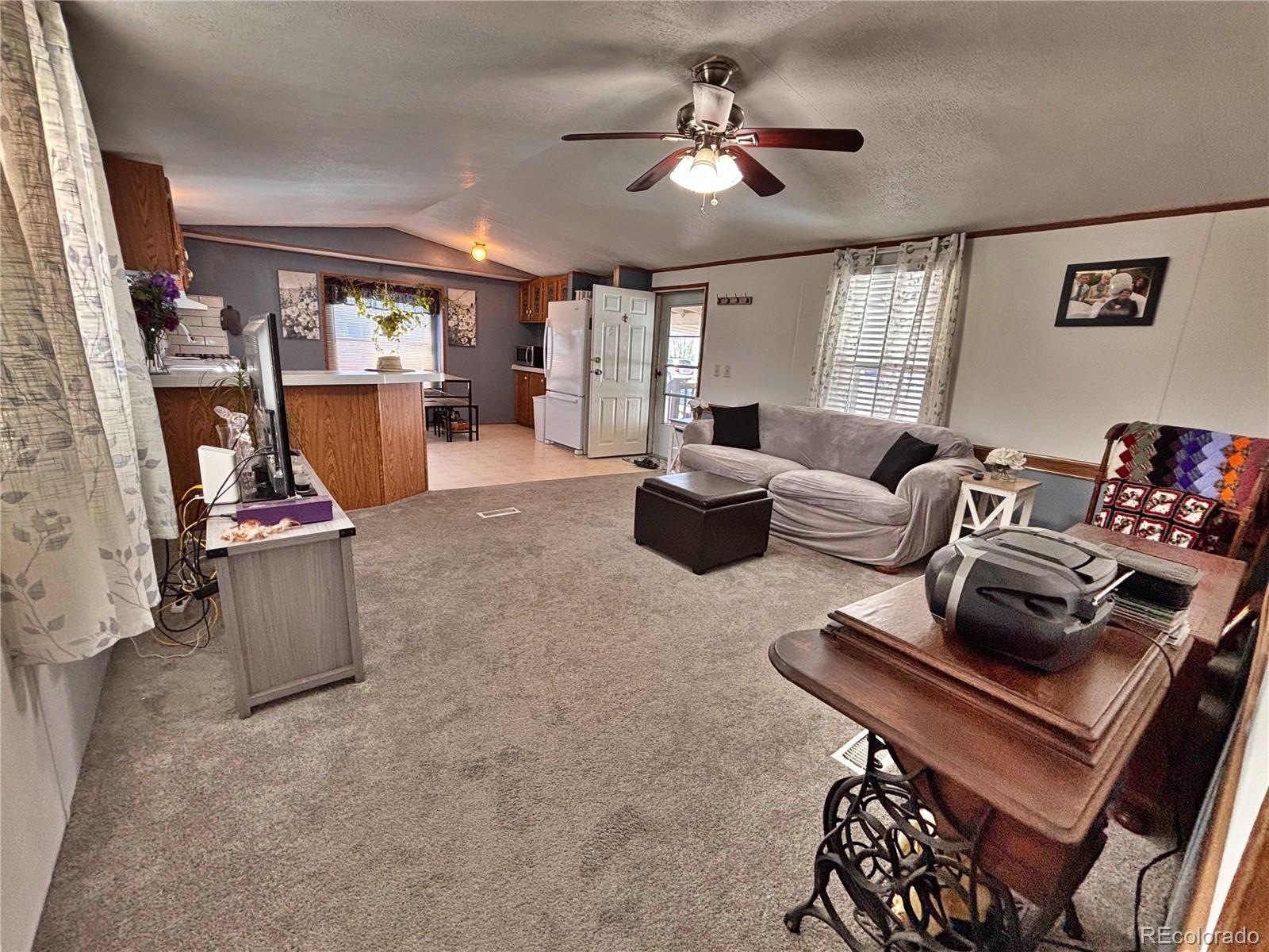 230 North 2nd Street Berthoud, CO 80513 - Photo 40 of 44 a living room with furniture ceiling fan and a window