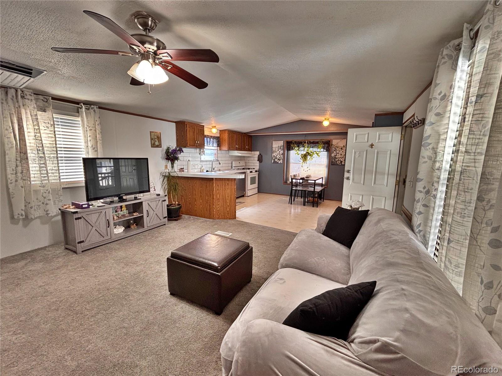 230 North 2nd Street Berthoud, CO 80513 - Photo 41 of 44 a living room with furniture and a flat screen tv