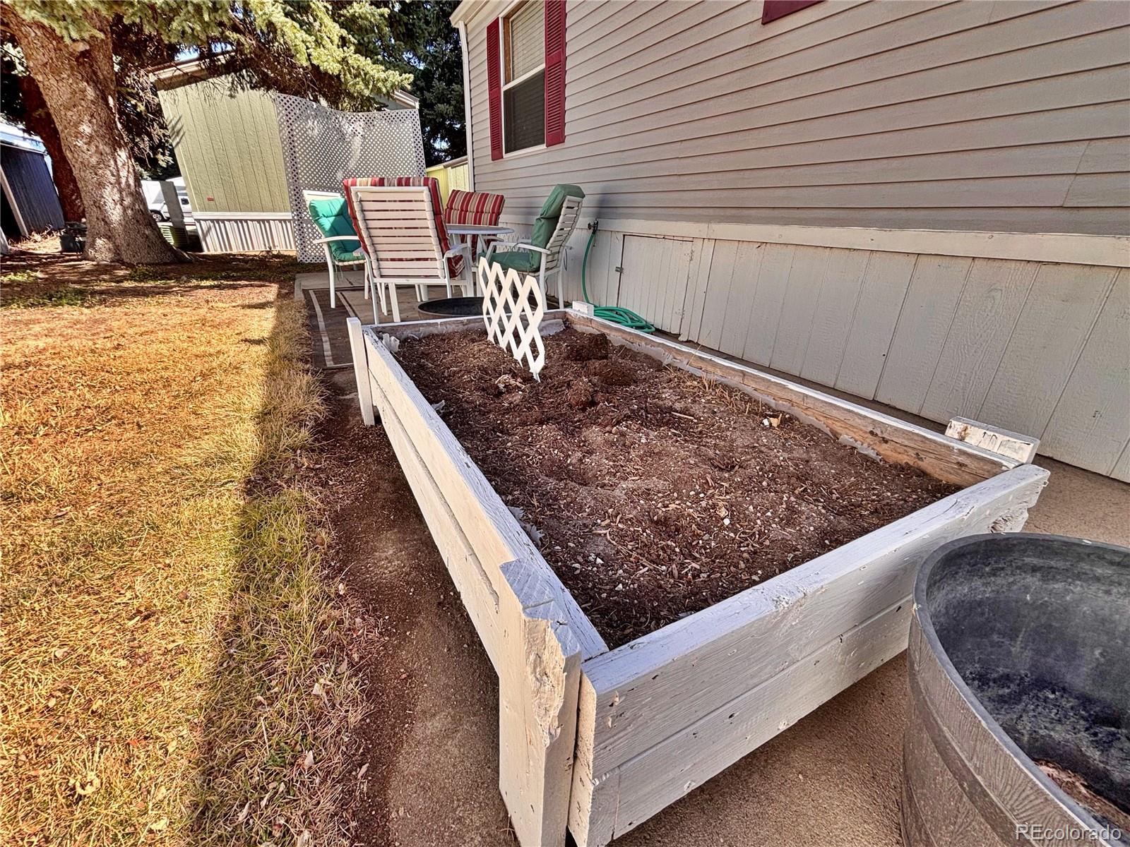 230 North 2nd Street Berthoud, CO 80513 - Photo 7 of 44 a view of roof deck with dining table and chairs with wooden floor and fence