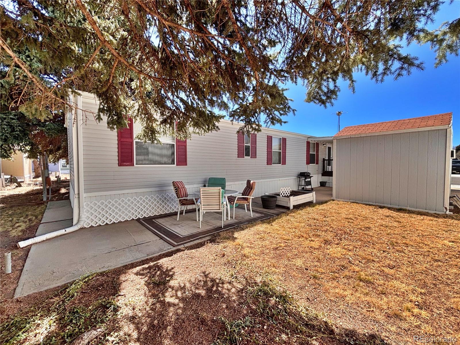 230 North 2nd Street Berthoud, CO 80513 - Photo 9 of 44 a backyard of a house with table and chairs