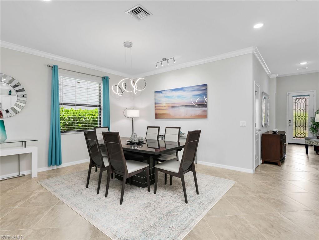 4383 Bismark Way Naples, FL 34119 - Photo 22 of 49 Dining Room with Track Lighting & Crown Molding Leading To Front Entry Foyer