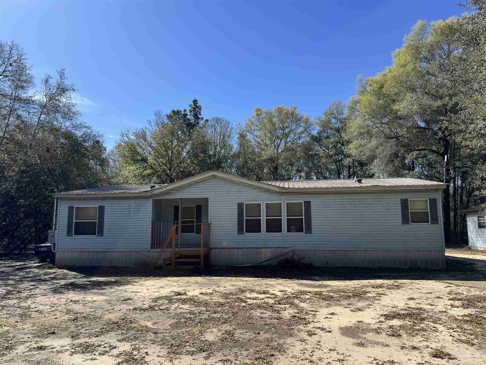 6512 Winston Brown Road Milton, FL 32570 - Photo 1 of 37 a house with trees in the background