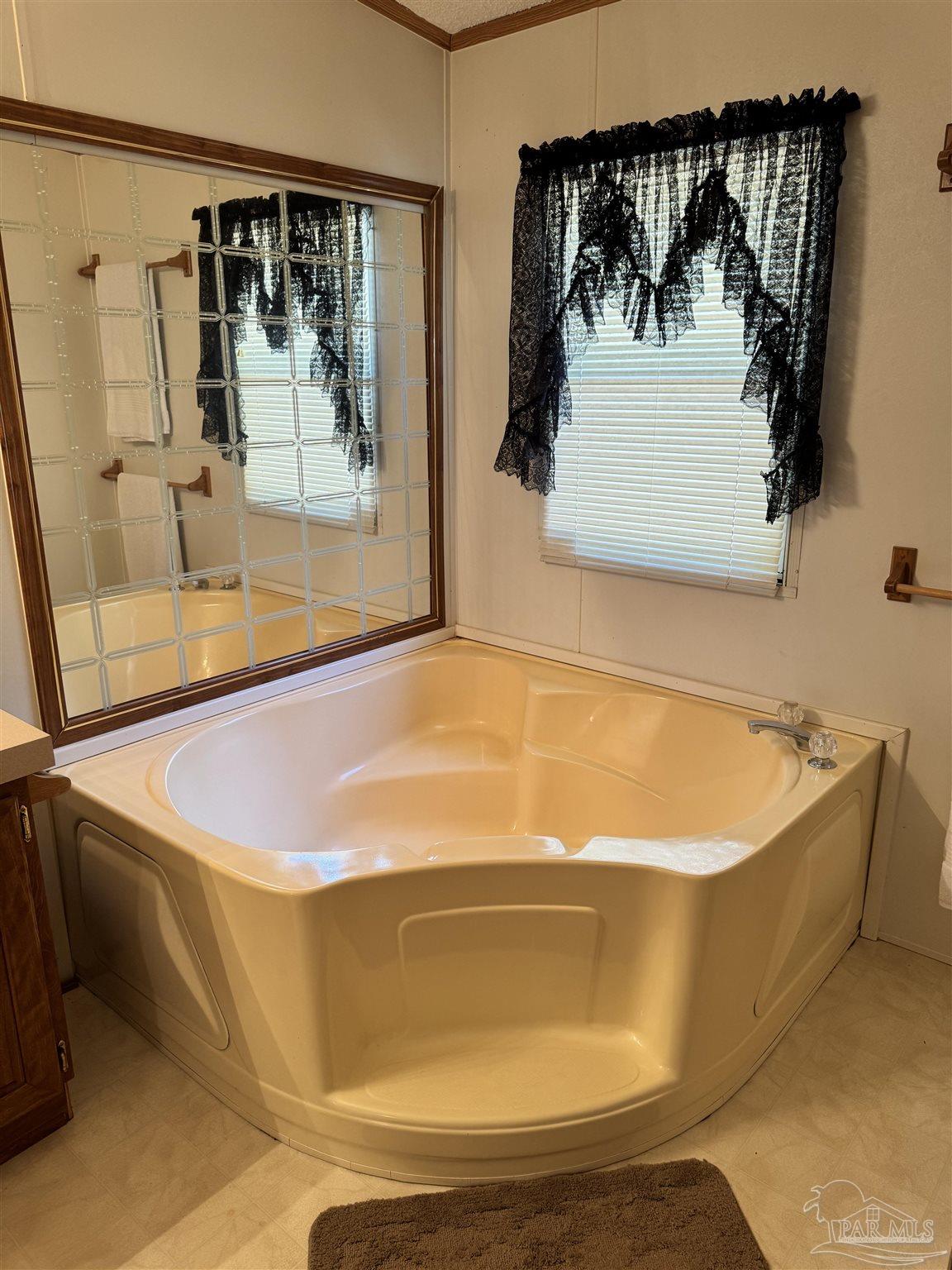 6512 Winston Brown Road Milton, FL 32570 - Photo 13 of 37 a bath tub sitting next to a glass door