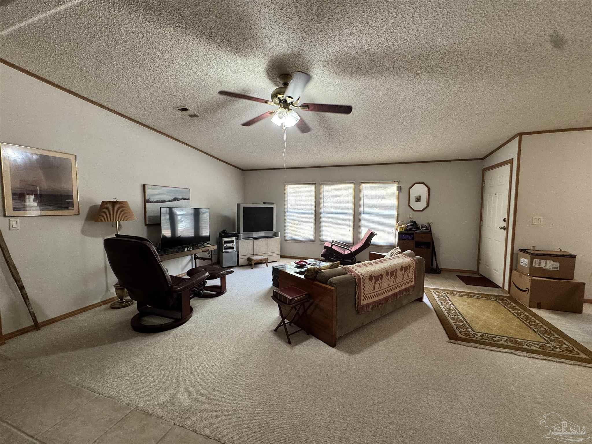 6512 Winston Brown Road Milton, FL 32570 - Photo 21 of 37 a living room with furniture ceiling fan and a rug