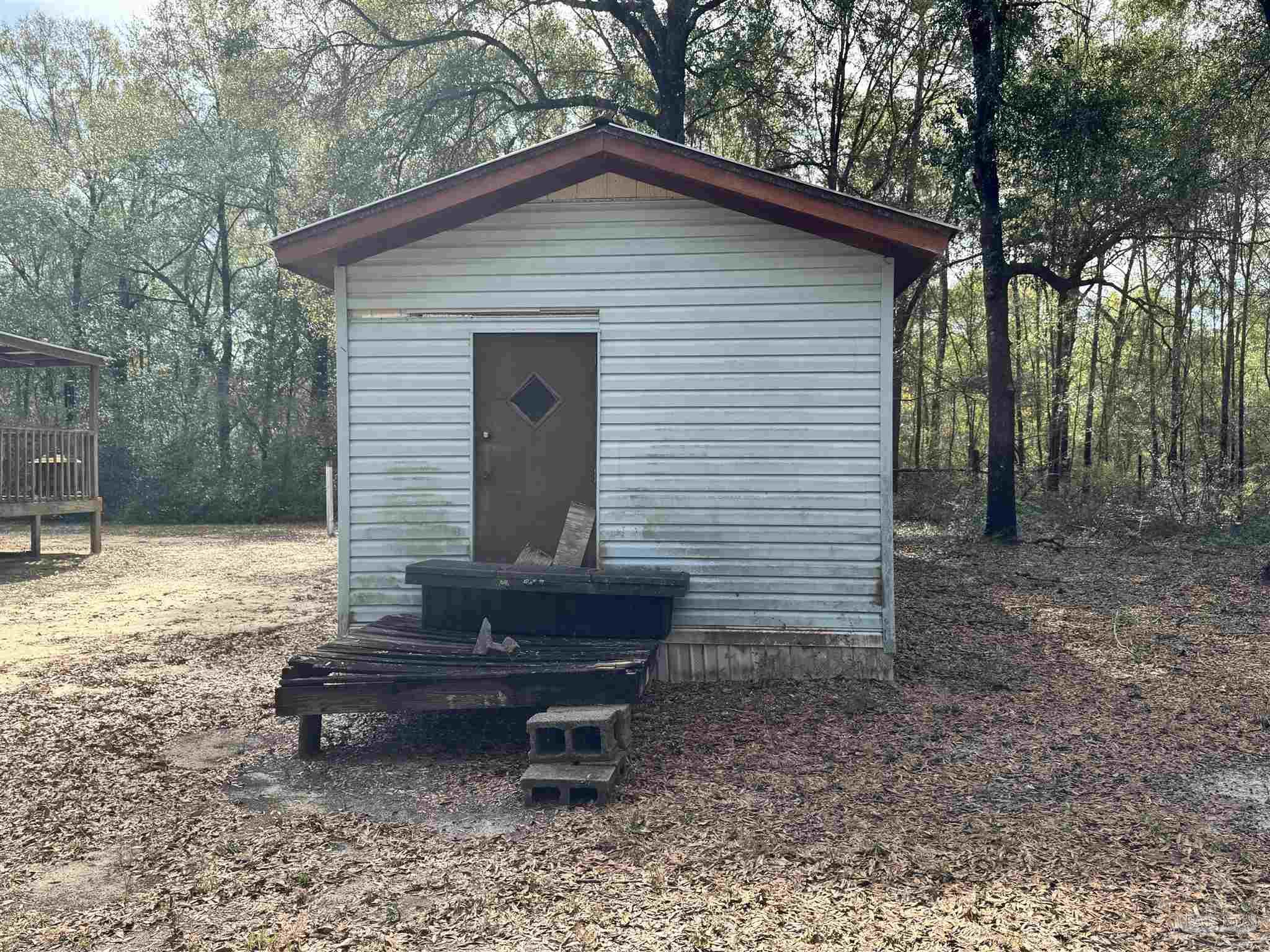 6512 Winston Brown Road Milton, FL 32570 - Photo 27 of 37 a view of a house with a yard and sitting area