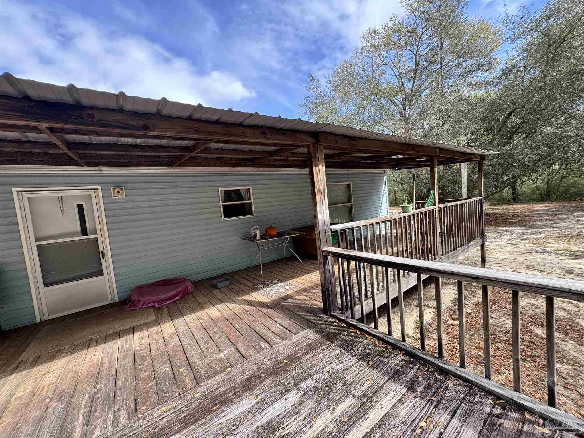6512 Winston Brown Road Milton, FL 32570 - Photo 32 of 37 a view of backyard with small cabin and wooden floor