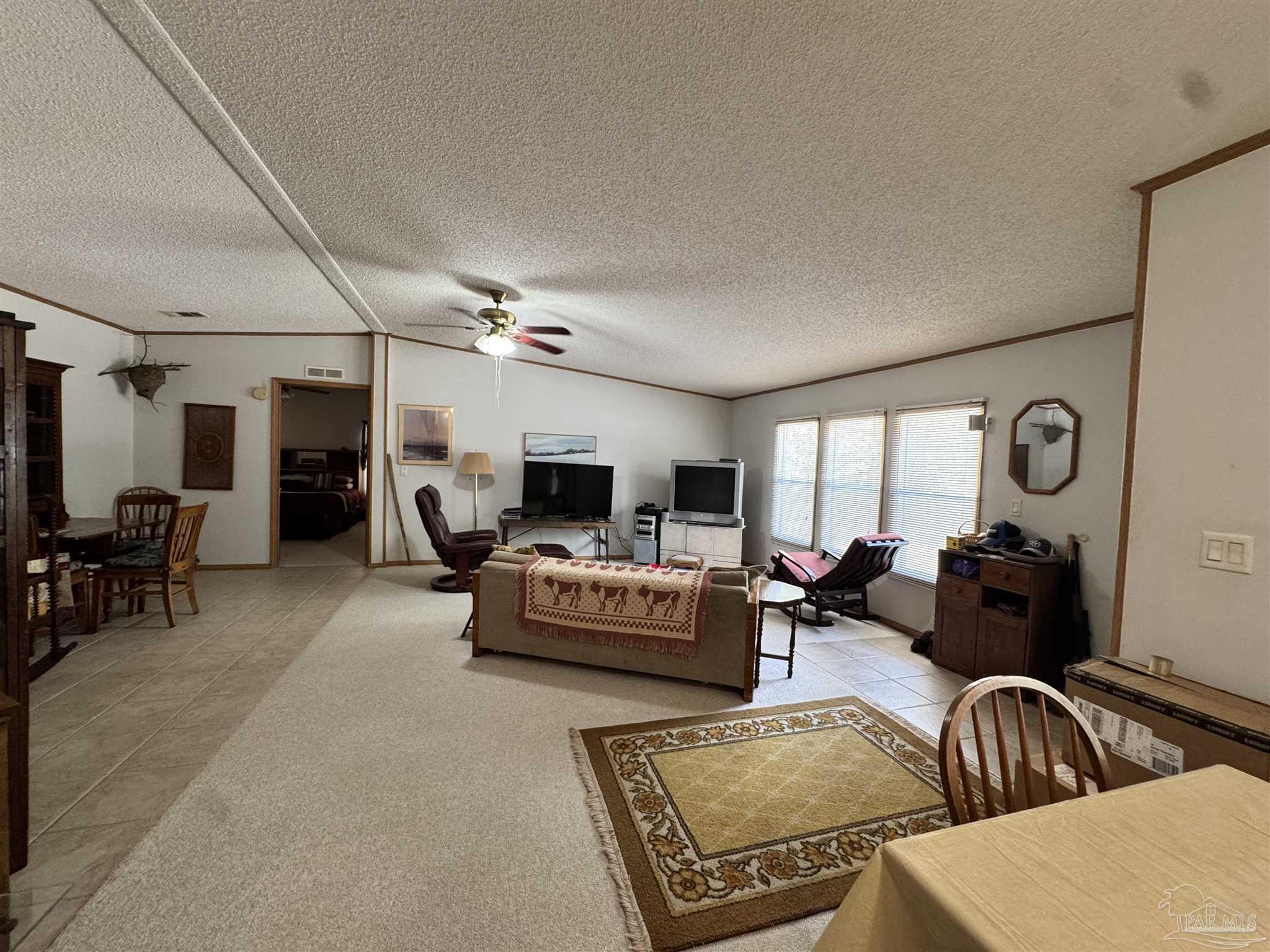 6512 Winston Brown Road Milton, FL 32570 - Photo 4 of 37 a living room with furniture and a flat screen tv