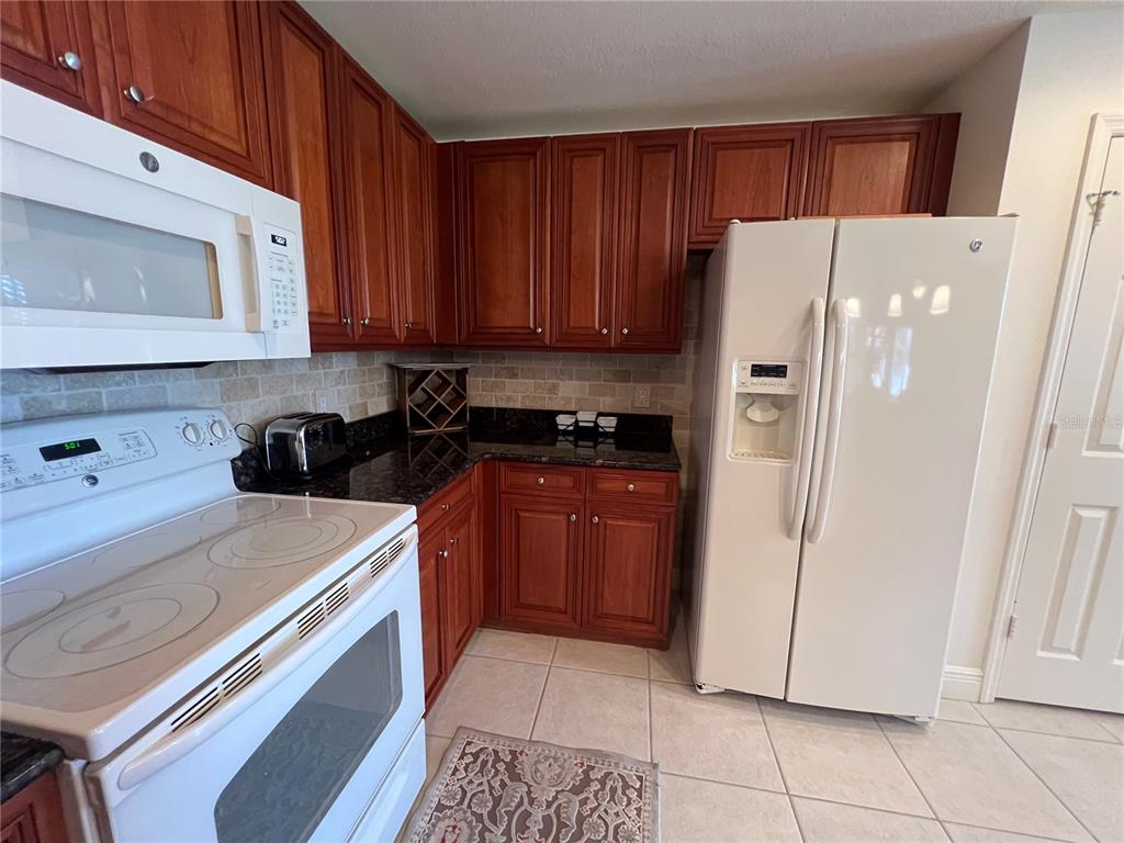 240 West End Drive, Unit 611 Punta Gorda, FL 33950 - Photo 12 of 19 a kitchen with a refrigerator sink and cabinets