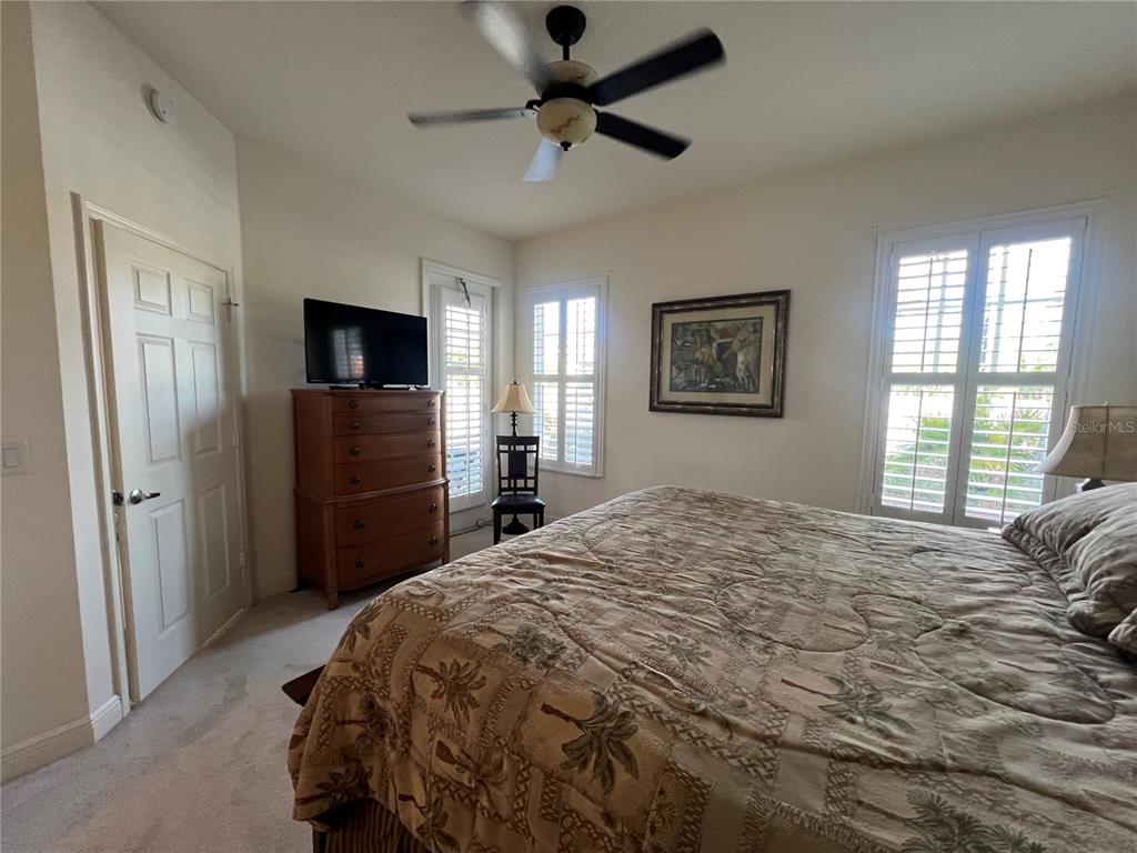 240 West End Drive, Unit 611 Punta Gorda, FL 33950 - Photo 14 of 19 a bedroom with a bed and a flat screen tv