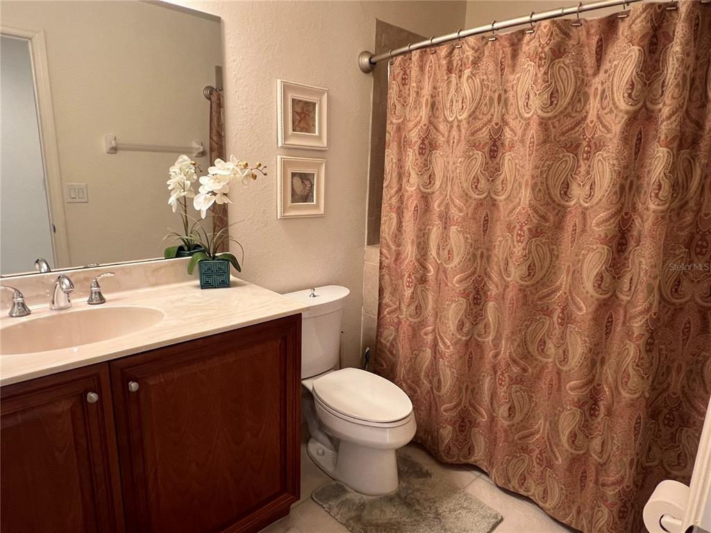 240 West End Drive, Unit 611 Punta Gorda, FL 33950 - Photo 18 of 19 a bathroom with a sink a toilet and shower curtain