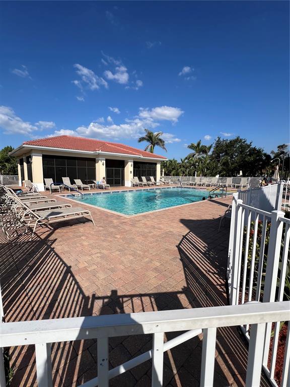 240 West End Drive, Unit 611 Punta Gorda, FL 33950 - Photo 19 of 19 a view of a patio with table and chairs with wooden floor and fence