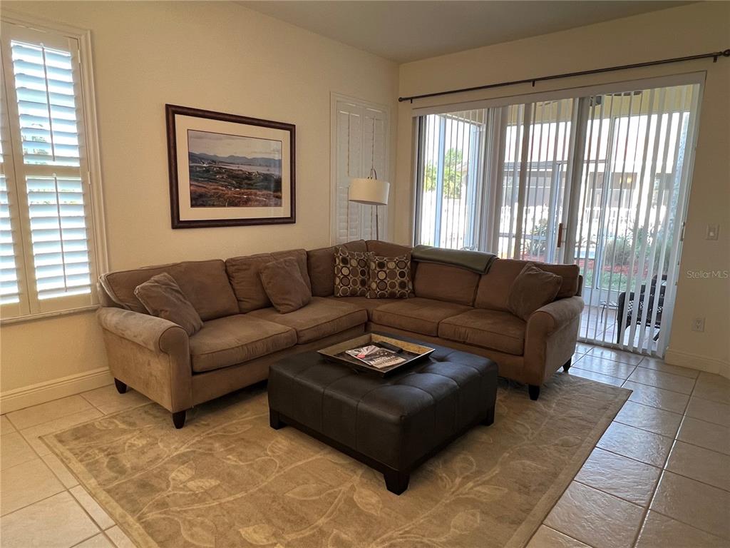 240 West End Drive, Unit 611 Punta Gorda, FL 33950 - Photo 2 of 19 a living room with furniture and a large window