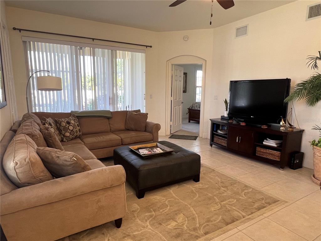 240 West End Drive, Unit 611 Punta Gorda, FL 33950 - Photo 3 of 19 a living room with furniture and a flat screen tv