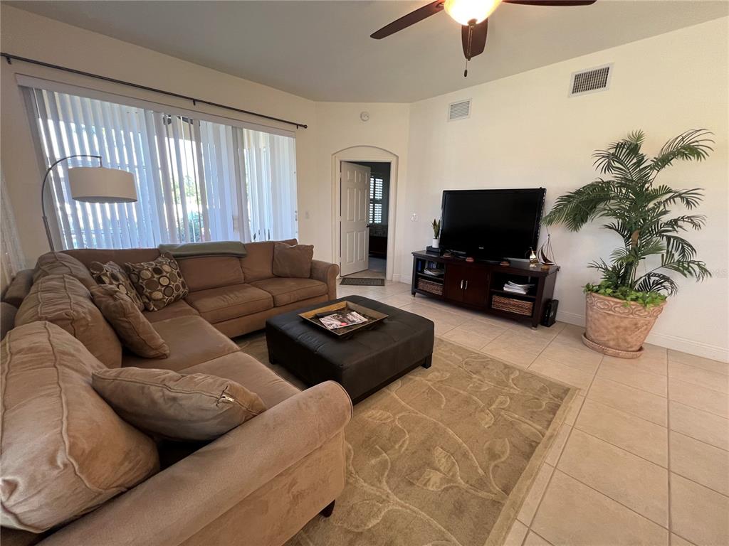 240 West End Drive, Unit 611 Punta Gorda, FL 33950 - Photo 4 of 19 a living room with furniture and a flat screen tv