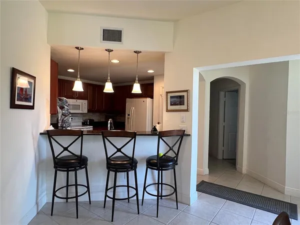 a view of a dining room with furniture and chandelier