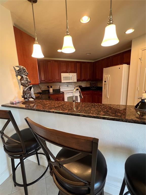 240 West End Drive, Unit 611 Punta Gorda, FL 33950 - Photo 9 of 19 a kitchen with a table chairs sink and cabinets