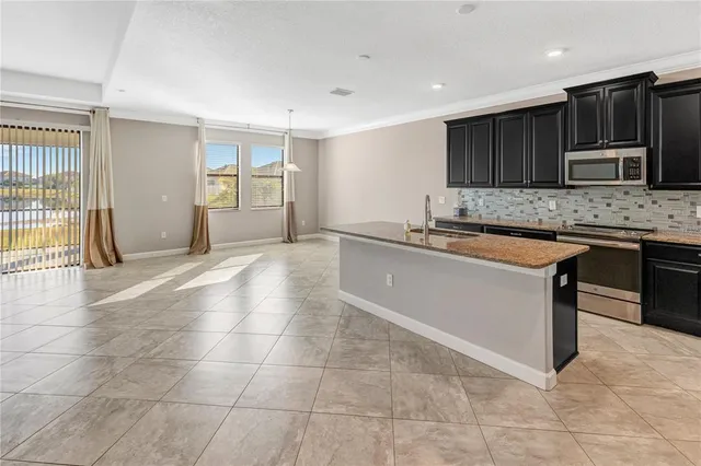 a view of a dining room with furniture and window