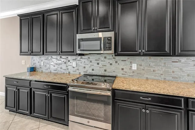 a view of an empty room and a ceiling fan