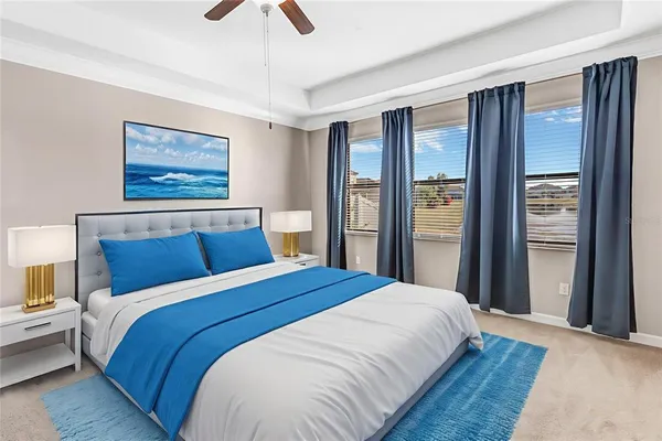 a bedroom with a large bed and a chandelier