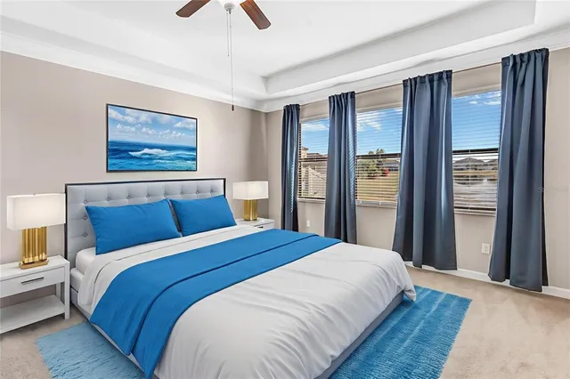 a bedroom with a large bed and a chandelier