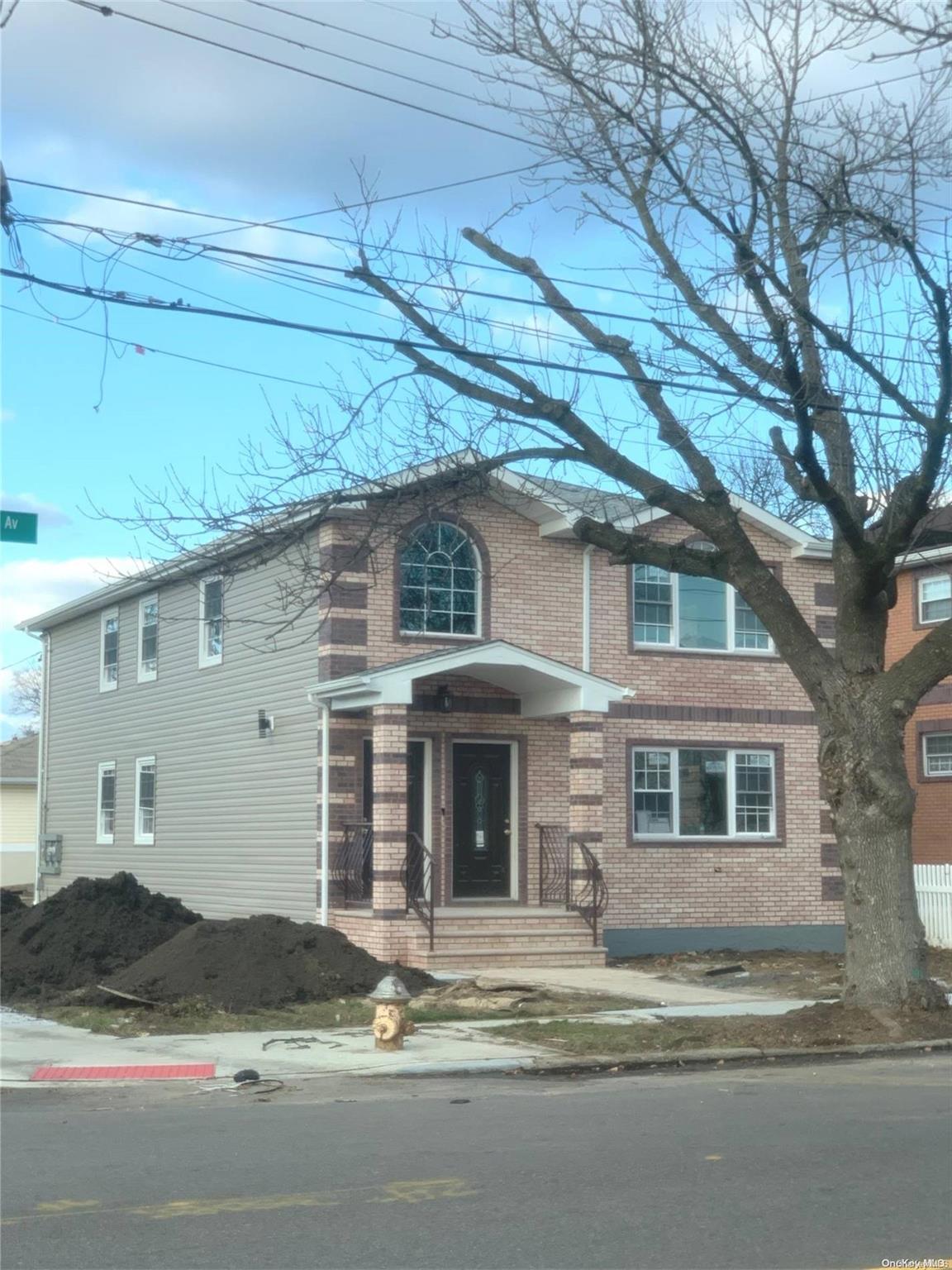 141-03 116th Avenue Queens, NY 11436 - Photo 2 of 4 a front view of a house with yard