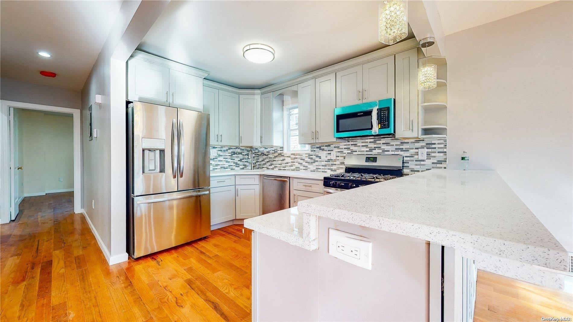141-03 116th Avenue Queens, NY 11436 - Photo 3 of 4 a kitchen with stainless steel appliances a refrigerator and a stove top oven