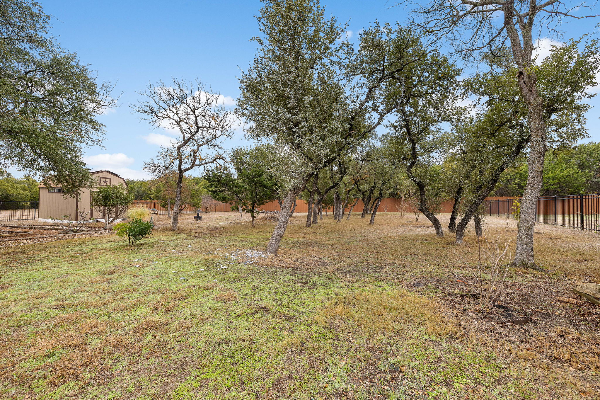 174 Estrella Crossing Georgetown, TX 78628 - Photo 33 of 38 View of yard with a storage unit and a view of countryside