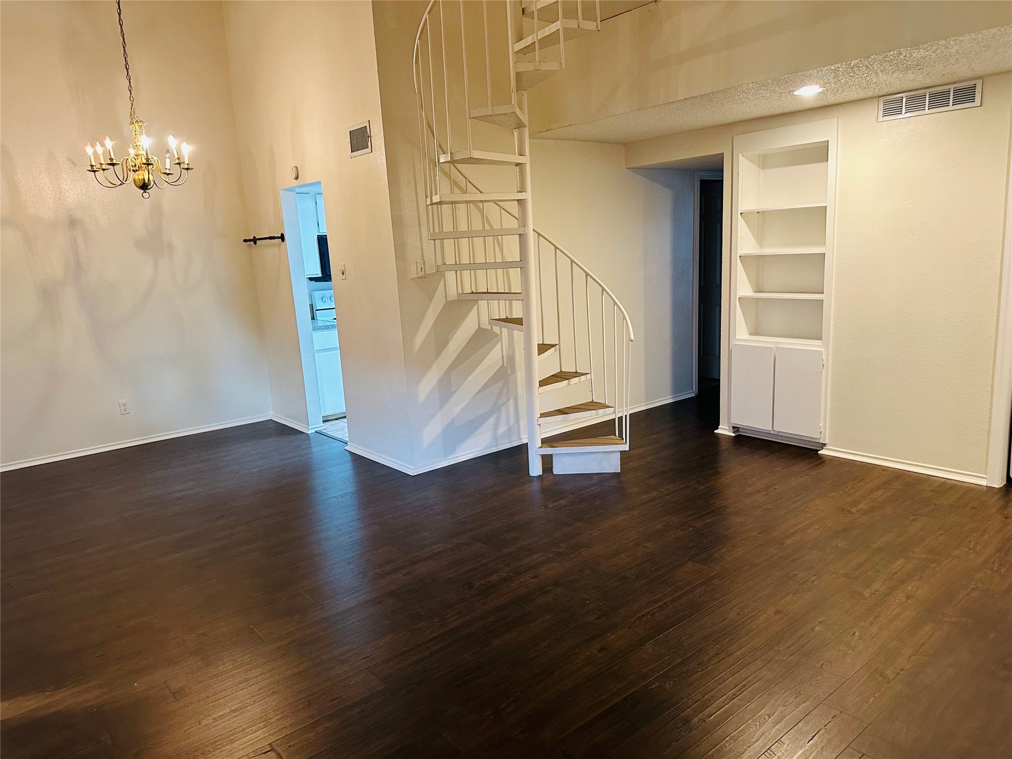 a view of a room with wooden floor and staircase