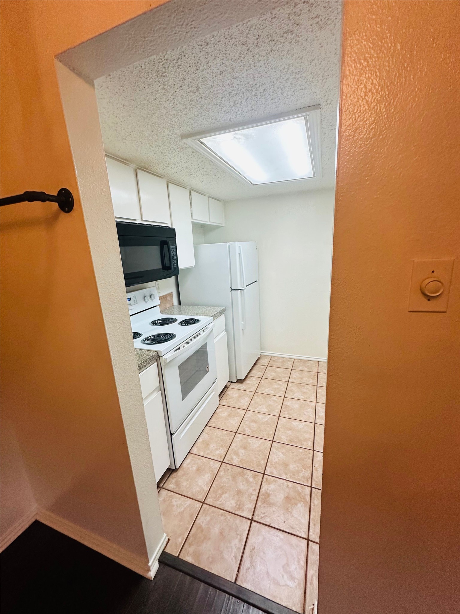 2401 Leon Street, Unit 307 Austin, TX 78705 - Photo 12 of 25 a kitchen with white cabinets and appliances