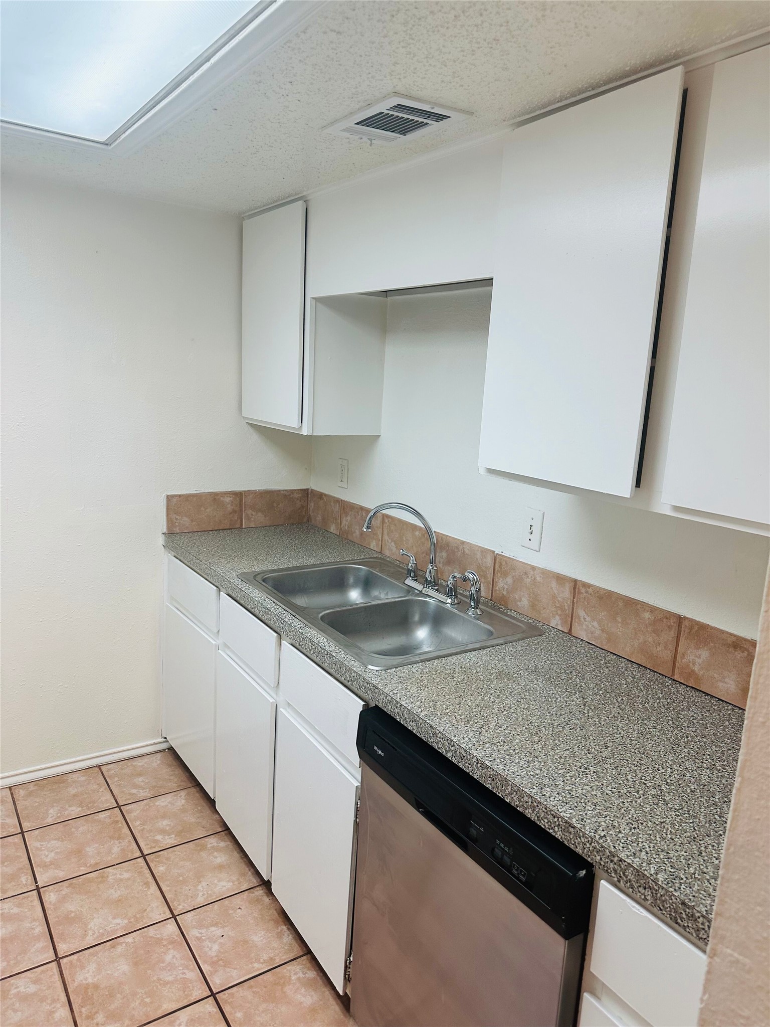 2401 Leon Street, Unit 307 Austin, TX 78705 - Photo 7 of 25 a kitchen with a sink and cabinets