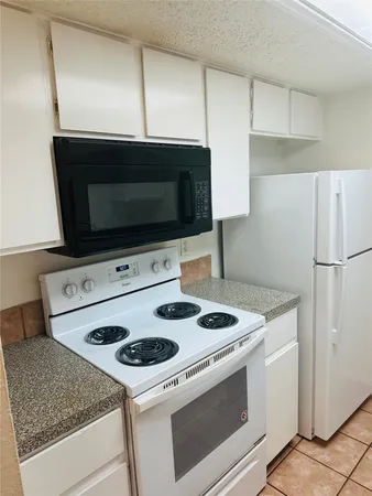 a kitchen with a stove and a microwave