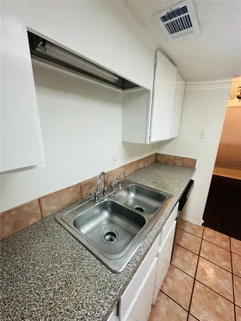 a kitchen with a sink a stove and a table