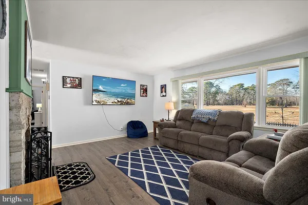 a living room with furniture a rug and a fireplace