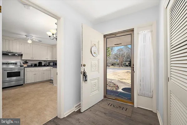 a view of a hallway with wooden floor and staircase