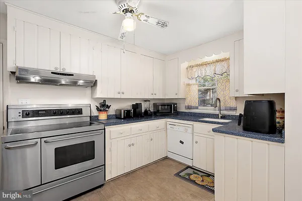 a kitchen with a stove a sink and a refrigerator